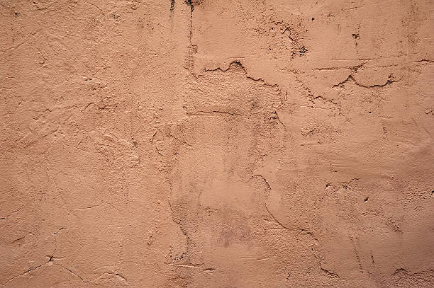 istock Texture of old wall covered with pink stucco 527314185