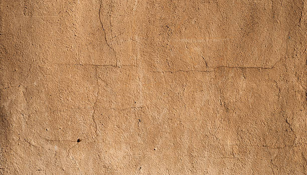 istock Texture of old  wall covered with yellow stucco 527314591