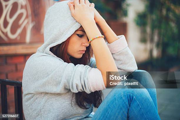 Depressed Teen Girl Sitting Lonely Stock Photo - Download Image Now - Adolescence, Street, Teenage Girls