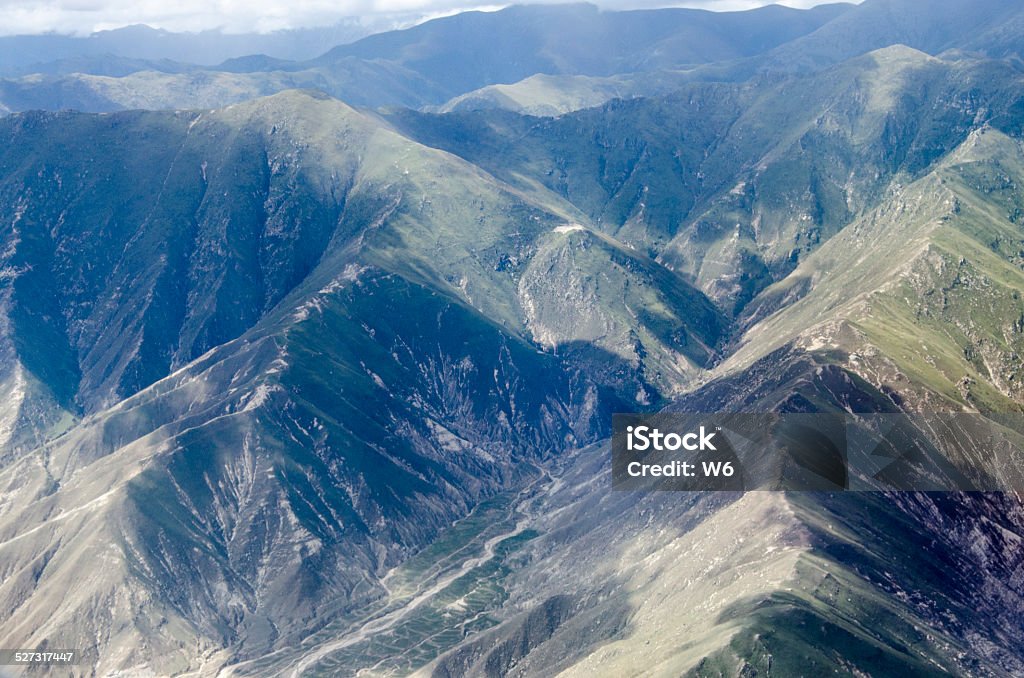 Mountain range in Tibet Mountain range in Tibet,  View from the airplane.https://lh5.googleusercontent.com/-tpvJ64X4LmY/VMUQwuBJZOI/AAAAAAAABAA/4xrt9UufxvI/s380/banner_Tibet.png Adventure Stock Photo