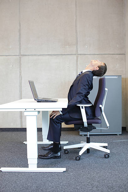 istock Office occupational disease prevention - business man exercising at workstation 527319509
