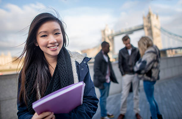 Asian woman studying English Happy Asian woman studying English in London exchange student stock pictures, royalty-free photos & images