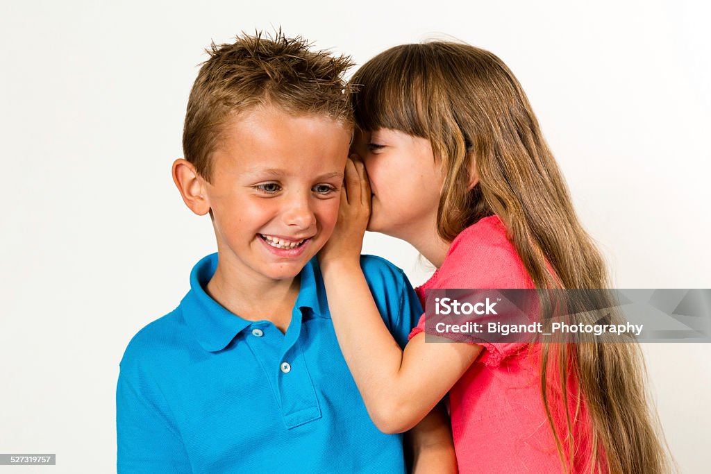 Girl Telling Funny Story To Boy Stock Photo - Download Image Now - Boys,  Child, Whispering - iStock