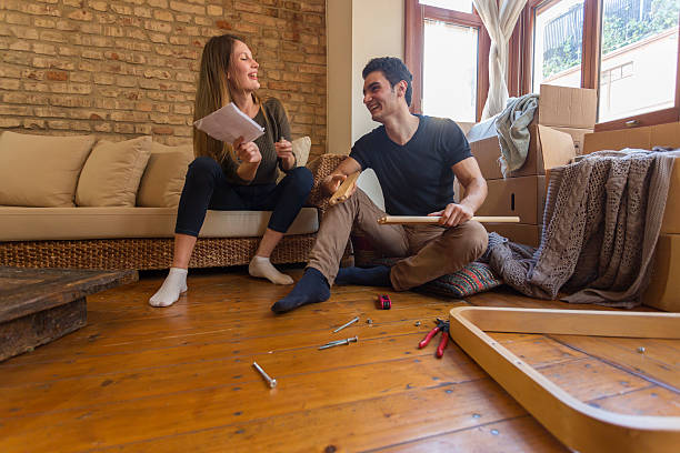 istock Couple Moving In and Assembling Furniture 527343925
