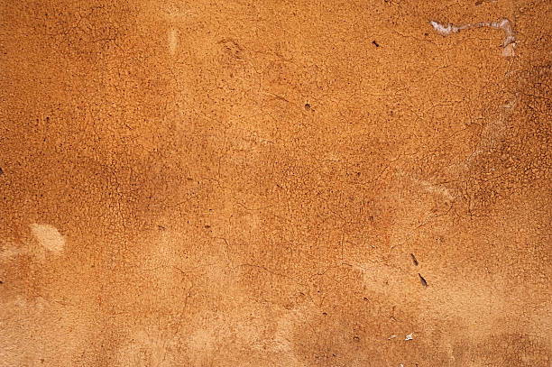 istock Texture of old wall covered with brown stucco 527344217