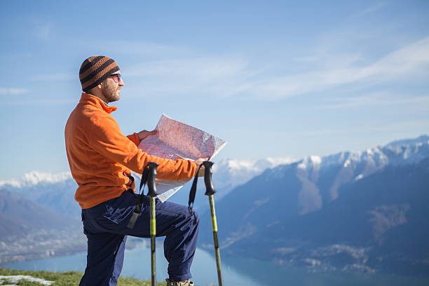 istock Tourist hiking in high mountain reading map for directions 527344953