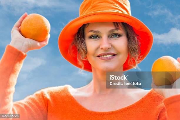 Woman Holding Two Oranges Stock Photo - Download Image Now - Adult, Adults Only, Beautiful People