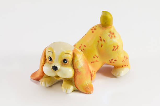 istock Statuette of dog sitting on white background 527369423