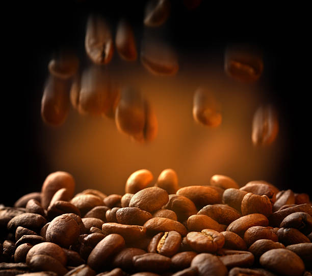 Brown coffee beans falling down Brown coffee beans falling down