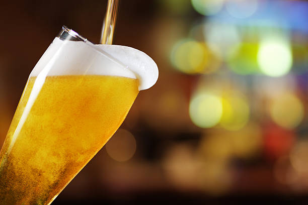 Glass of beer Inclined Glass of beer  pouring stock pictures, royalty-free photos & images