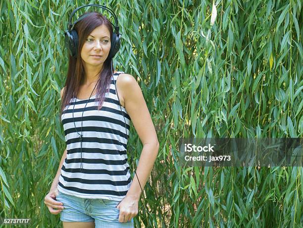 Woman Listening To Music Stock Photo - Download Image Now - Adult, Adults Only, Agricultural Field