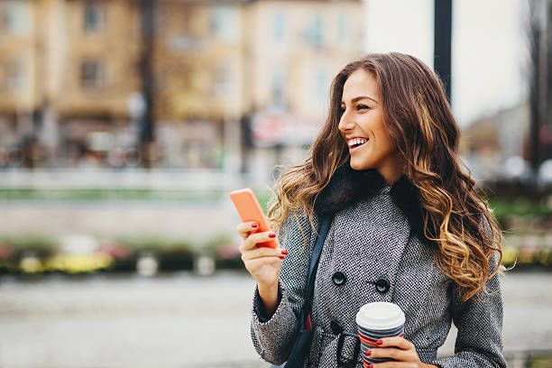 istock Young woman texting on smart phone 527371871