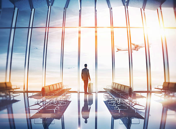istock Businessman at airport with suitcase 527372221