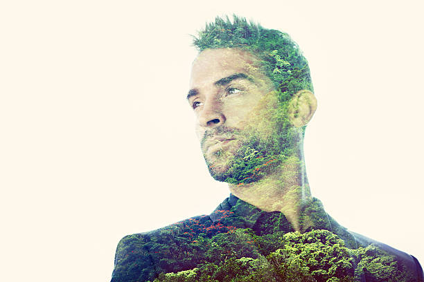 Composite image of a handsome man superimposed with an image of a forest