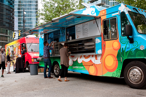Atlanta, GA, USA - October 16, 2014:  Customers order meals from a popular food truck during their lunch hour, at \