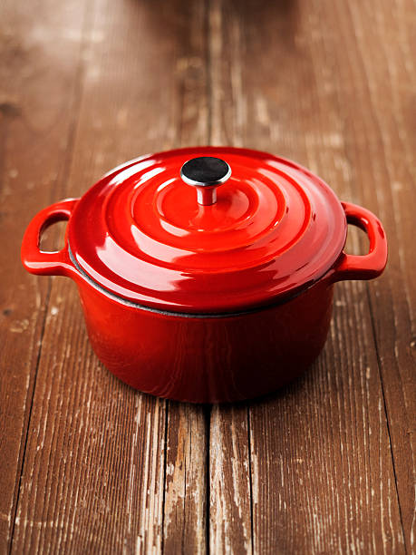 istock Red cocotte pot on brown wooden table 527374265