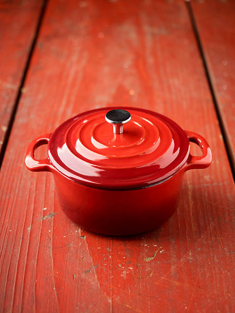 istock Red cocotte pot on red wooden table 527374367