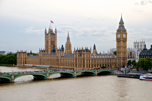 View past seasonal tree color to Great Clock of Westminster, British cultural icon in Gothic Revival style, opened in 1859, UNESCO World Heritage Site.