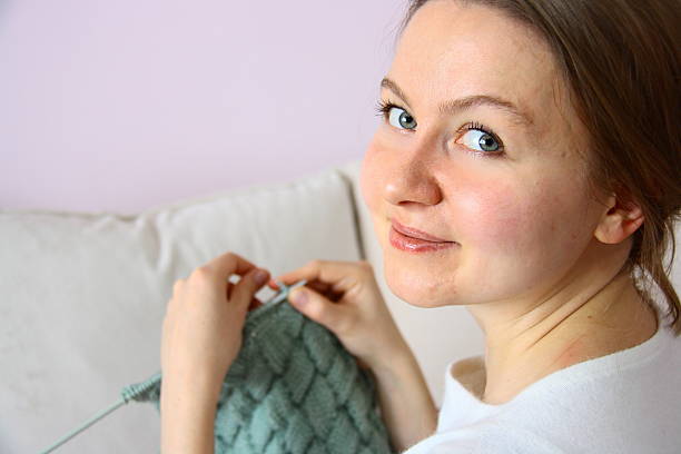 istock young woman knitting 527375283