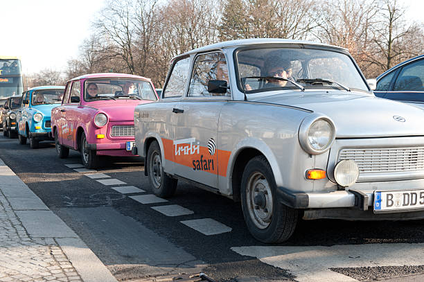 Berlin, Germany - January 29, 2011: Row of colored Trabant cars driving in the streets of Berlin