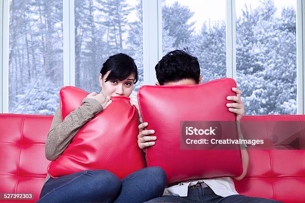 Couple Hiding On The Pillows Stock Photo - Download Image Now - 20-24 Years, Adult, Arts Culture and Entertainment