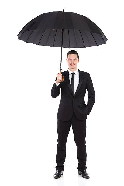 istock Smiling businessman standing with open umbrella 527392707