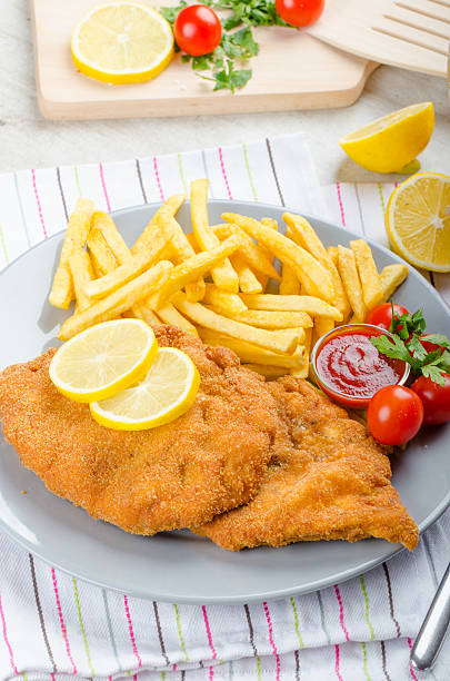 istock Schnitzel with french fries and a spicy dip 527393401