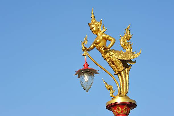 istock Gloden statue lamp on blue sky 527394743
