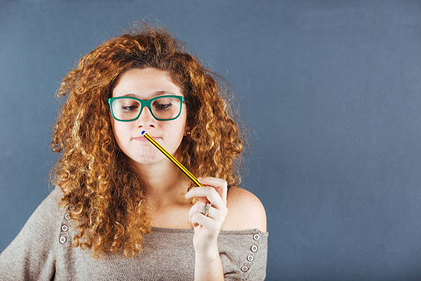 istock Pensive Curly Young Woman on Gray Background 527397661