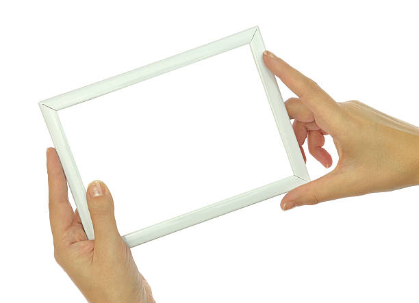 istock Hands holding blank photo frame isolated on white background 527398387