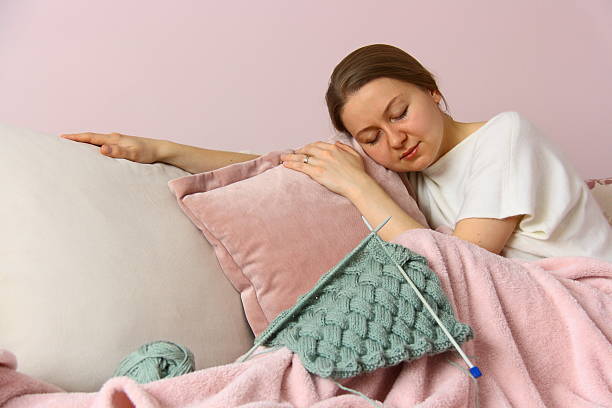istock young woman knitting 527399757