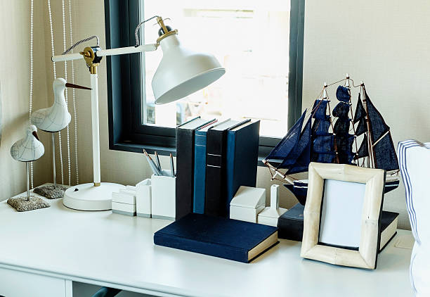 istock work table with lamp,pencil, books in a home 527439559