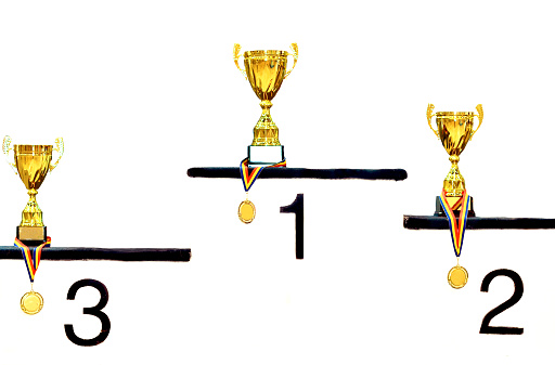 White pedestal with first, second and third places and winner cups.