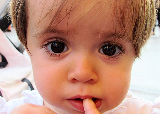istock Beatiful baby with her finger in his mouth. 527442623