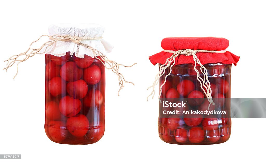 cherry compotes isolated two cherry compote in glass jar, isolated on white background Berry Fruit Stock Photo