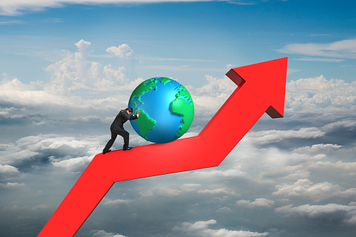 businessman push globe upward on red trend line with cumulus cloudscape background