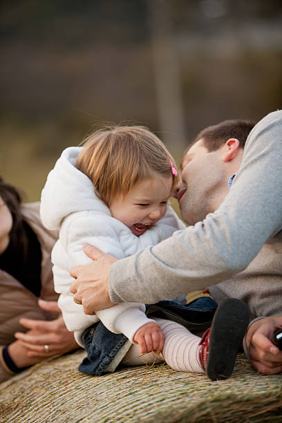 istock father kissing his laughing daughter 527444249