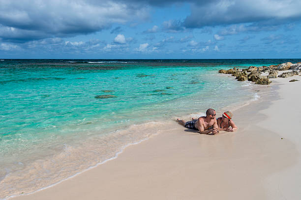 istock Couple relax in gentle surf, beach 527444323