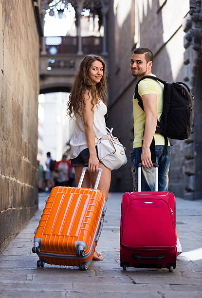 istock young pair with luggage walking through city 527462527