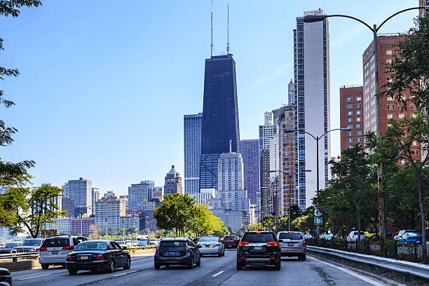 Traffic on Lake Shore Drive in Chicago A street level view of traffic driving on Lake Shore in Downtown Chicago with skyscrapers in the background including the Sear's tower. Blue sky is in the background. Room for copy space. lake shore drive chicago stock pictures, royalty-free photos & images