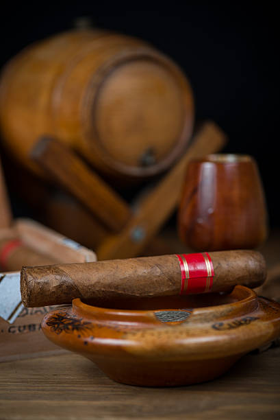 istock Cigars with barrel of rum on table 527465383