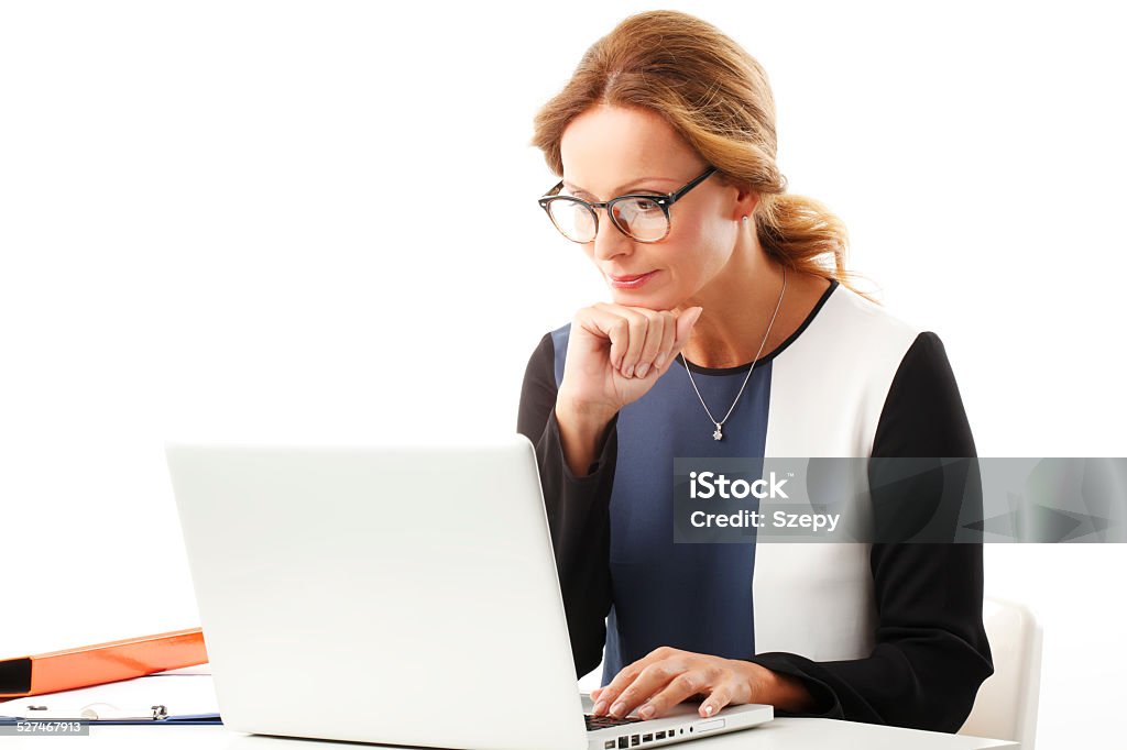 Sales woman portrait Business woman with laptop sitting at desk and typing. Isolated on white background. White Background Stock Photo