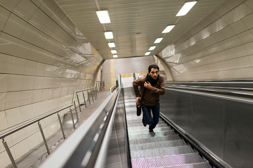 Man rushing up the escalator.
