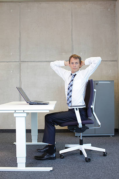 istock exercises in office. business man arm-neck stretching 527468295