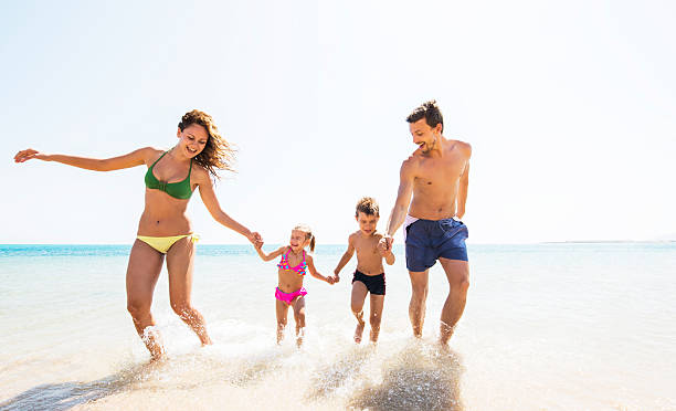 istock Family running through water. 527468737
