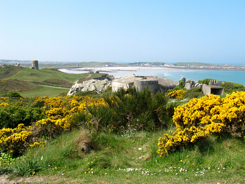 The view across L'Ancresse Common and L'Ancresse Bay with a Martello Tower visible to the left.  Guernsey, Channel Islands.