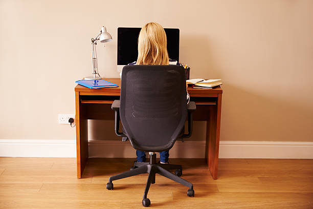 istock Woman Sitting At Desk Working At Computer In Home Office 527476817