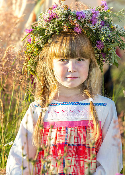 Portrait of beautiful little girl in flower wreath