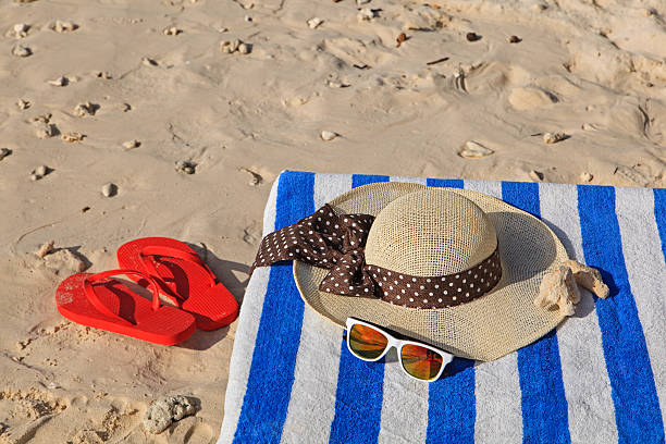istock Straw hat, towel, sunglasses and flip flops on a tropical 527477769