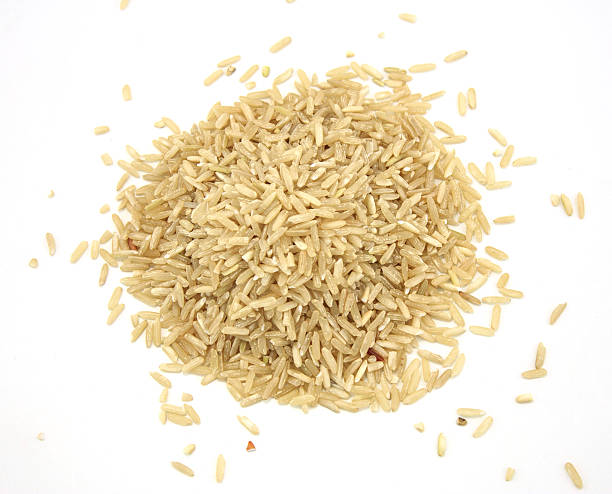 istock pile of brown rice isolated on white 527479281